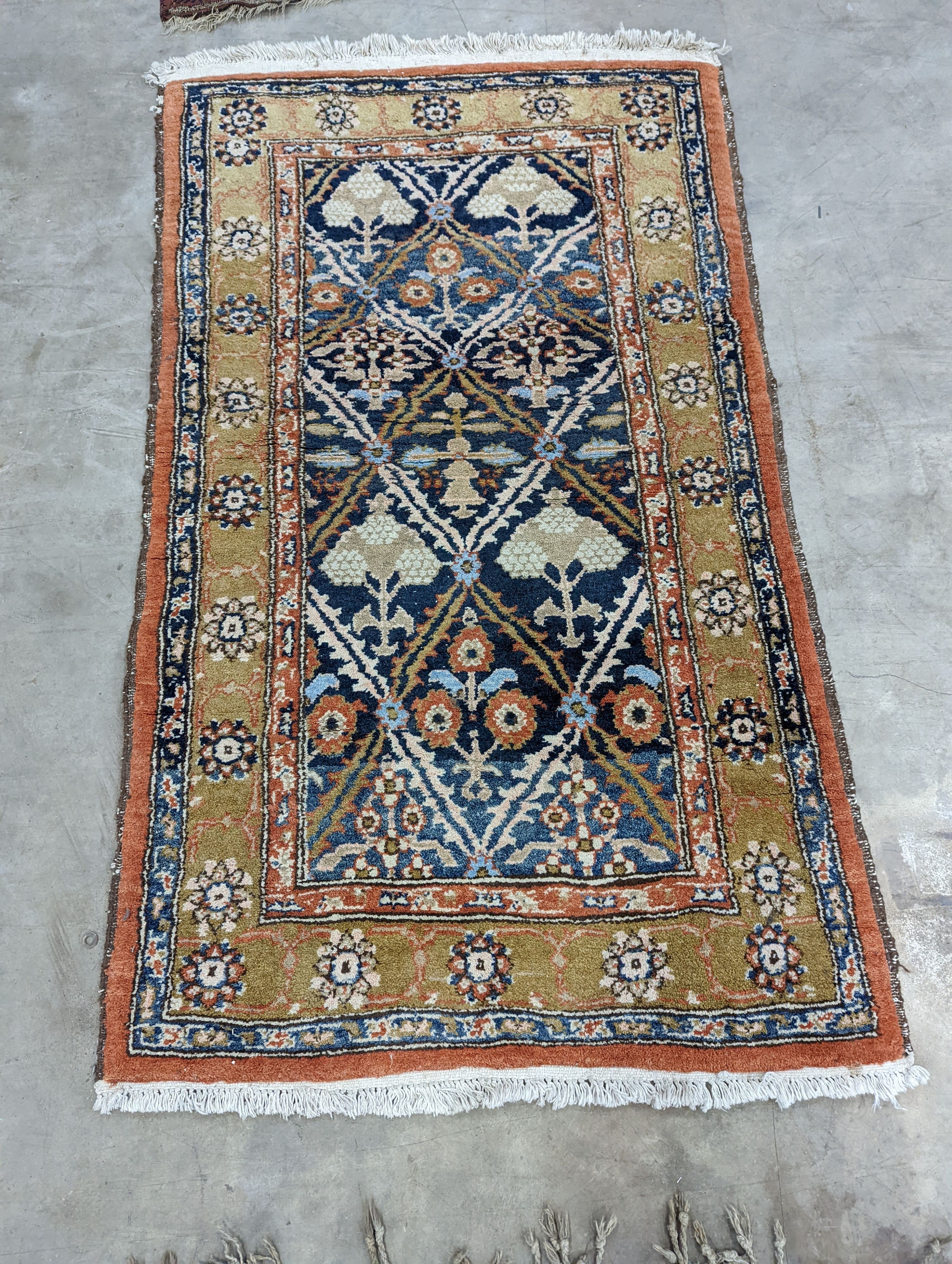 An Afghan brick red ground geometric runner and a smaller Afghan rug, larger 306 x 106cm